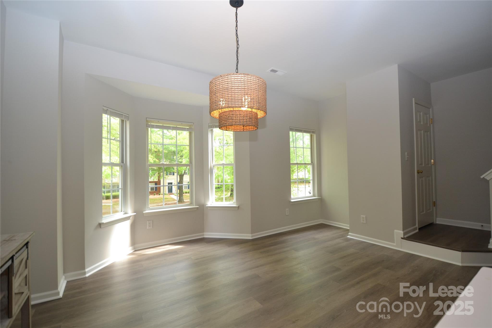 9647 Bailey Road Cornelius, NC 28031 - Photo 10 of 29 a view of empty room with wooden floor and fan
