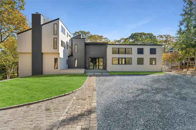 a view of empty room with wooden floor and fireplace