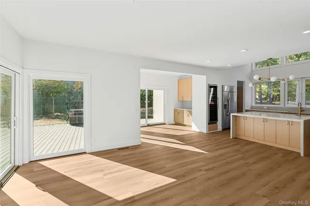 a view of empty room with wooden floor and fireplace