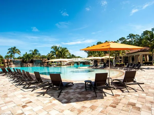 a swimming pool with outdoor seating and yard
