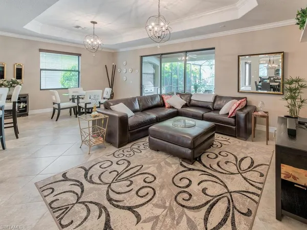a living room with furniture a chandelier and a table