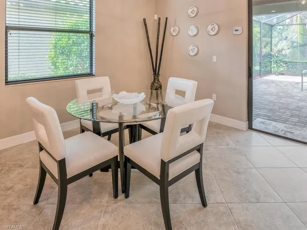 a view of a dining room with furniture and a window