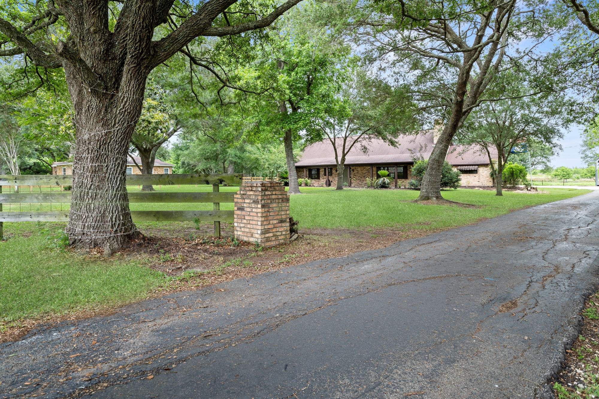 1747 Farm To Market Road 365 Nome, TX 77629 - Photo 12 of 24 a front view of a house with a yard and large trees