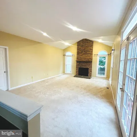 a view of an empty room with a fireplace