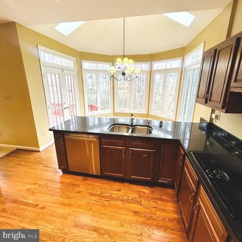 a kitchen with granite countertop a sink and a stove