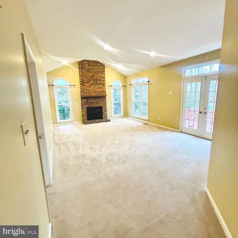 a view of an empty room with a fireplace