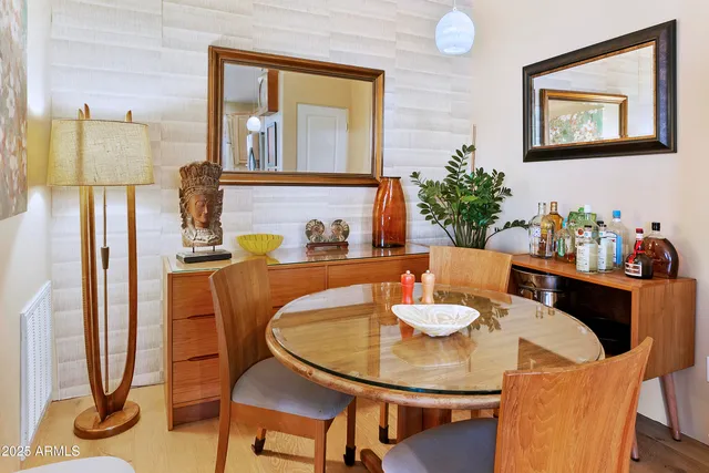a dining room with furniture and a floor to ceiling window