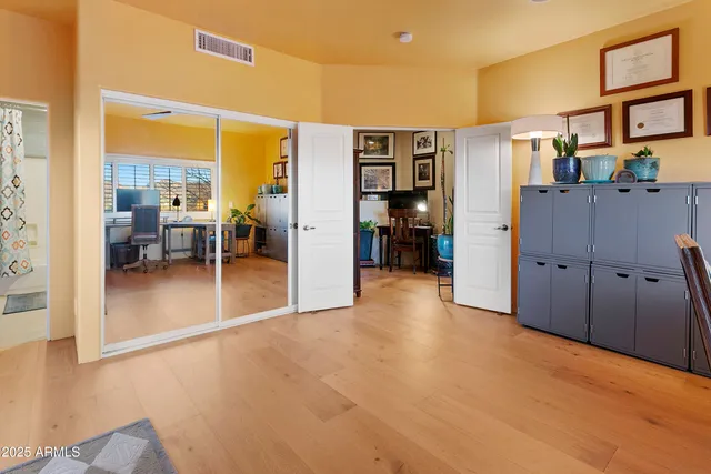 a view of a livingroom with furniture and a refrigerator