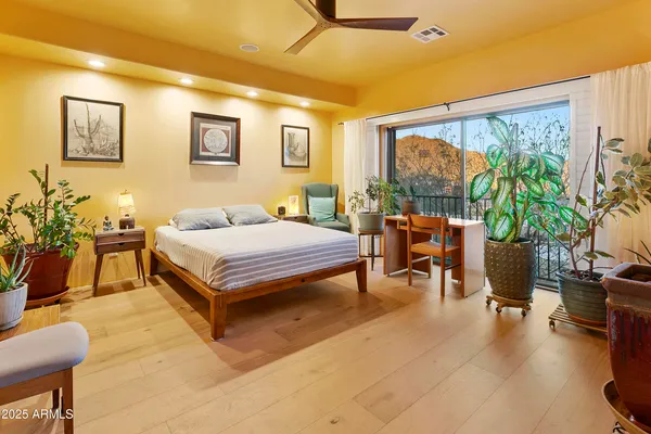 a bedroom with a bed and a large window