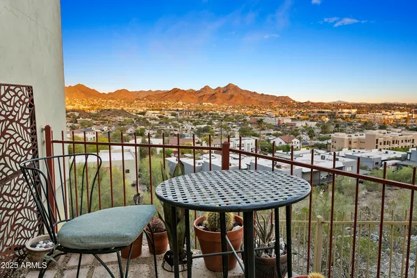 a view of a balcony with table and chairs