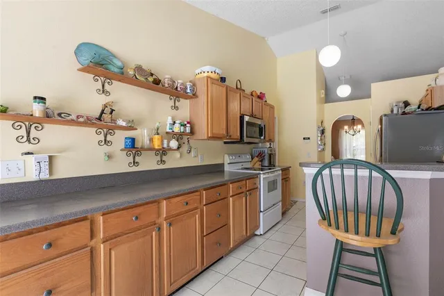 a kitchen with stainless steel appliances granite countertop a sink and cabinets