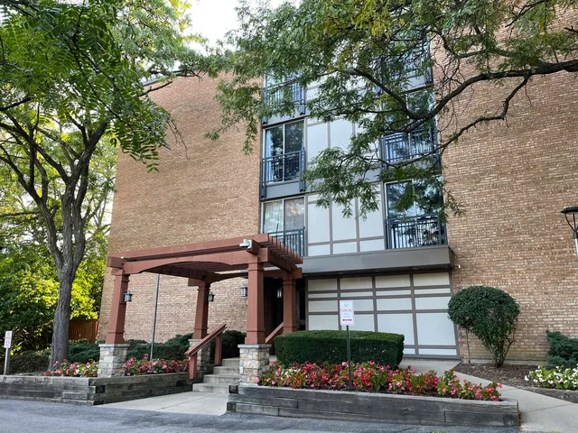 a front view of house with a garden