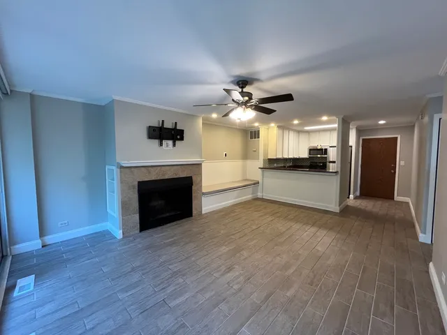 a view of a livingroom with a fireplace and a kitchen