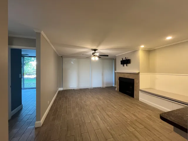 wooden floor in an empty room with a fireplace