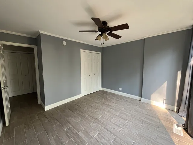 a view of a livingroom with wooden floor and a ceiling fan