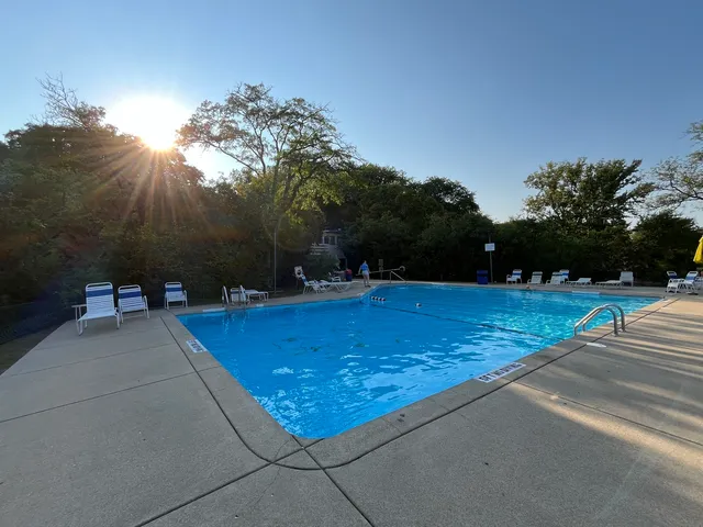 a view of a swimming pool with a table and chairs