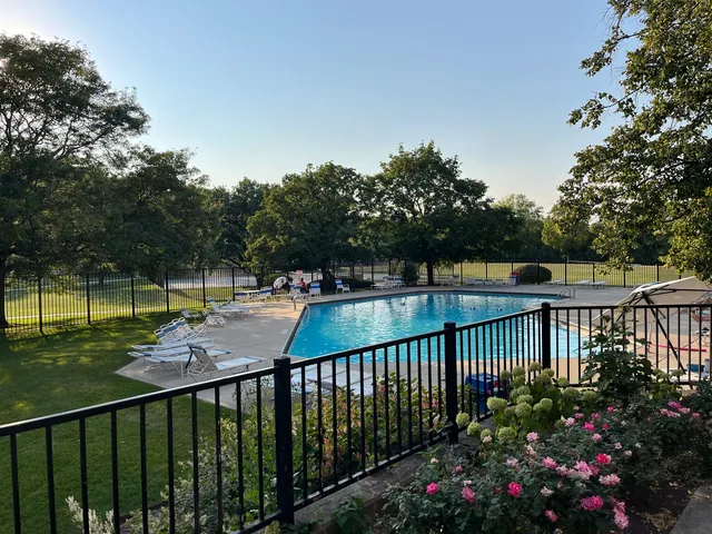 a view of a swimming pool with a yard