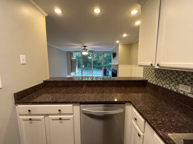 a kitchen with counter top space cabinets and appliances
