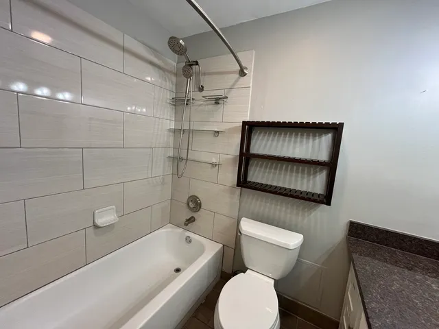 a bathroom with a toilet a sink and bathtub