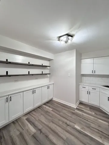 a view of a kitchen with a sink cabinets and wooden floor