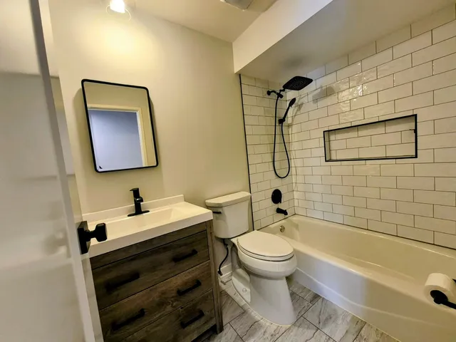 a bathroom with a sink toilet and shower