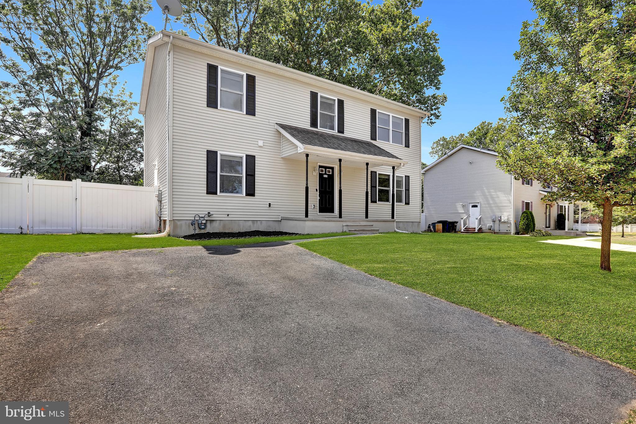 515 Ridge Avenue Hamilton, NJ 08610 - Photo 1 of 30 a front view of a house with a garden and trees
