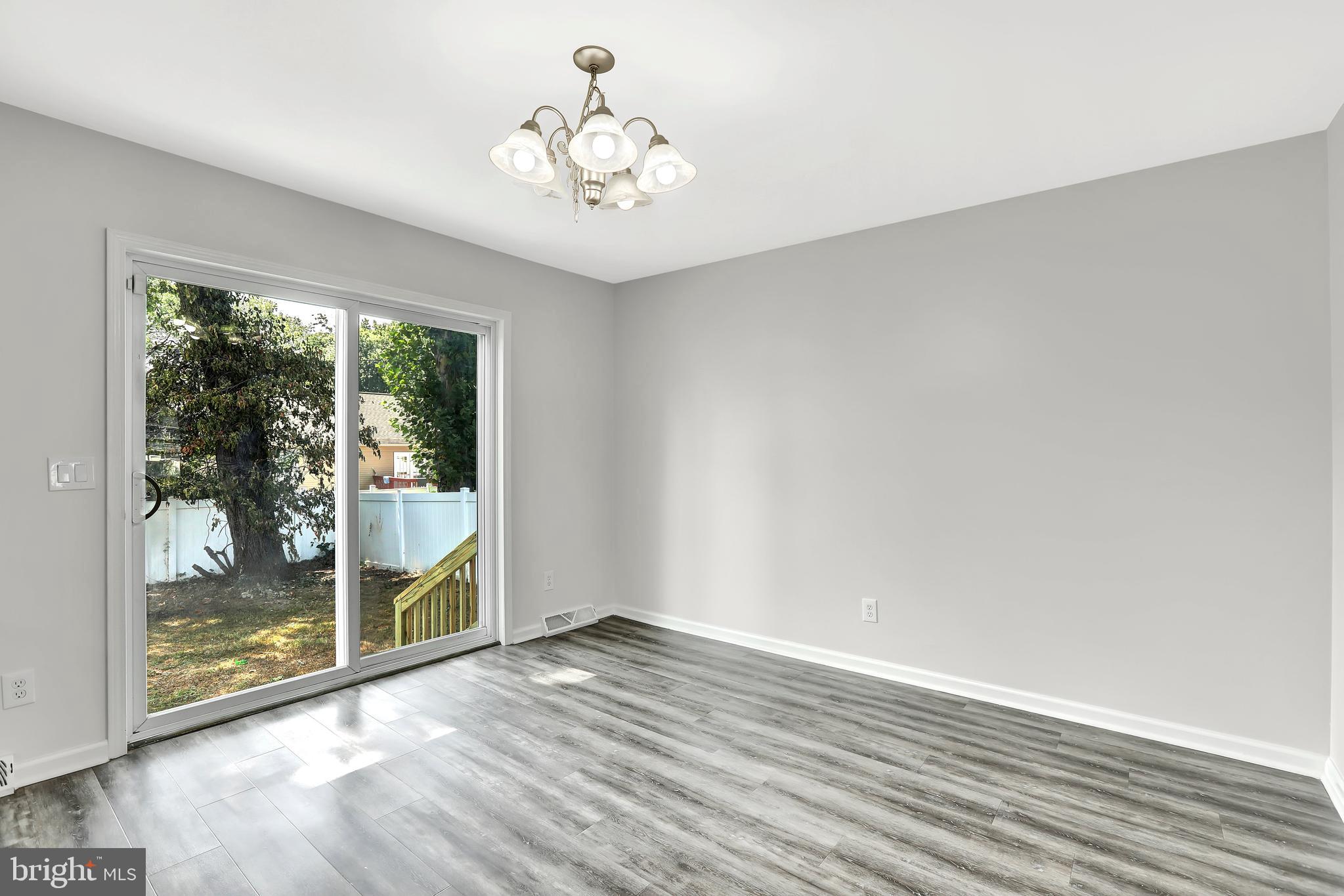 515 Ridge Avenue Hamilton, NJ 08610 - Photo 11 of 30 a view of an empty room with wooden floor and a window