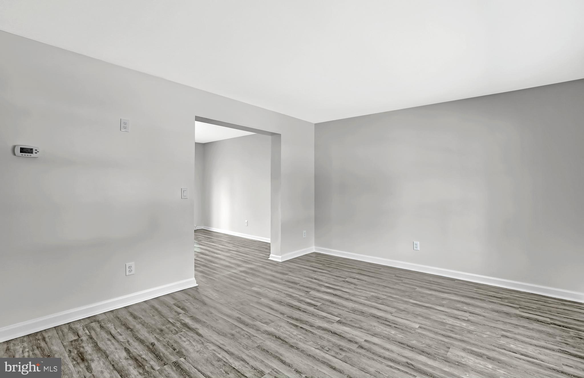 515 Ridge Avenue Hamilton, NJ 08610 - Photo 12 of 30 a view of an empty room with wooden floor and a window