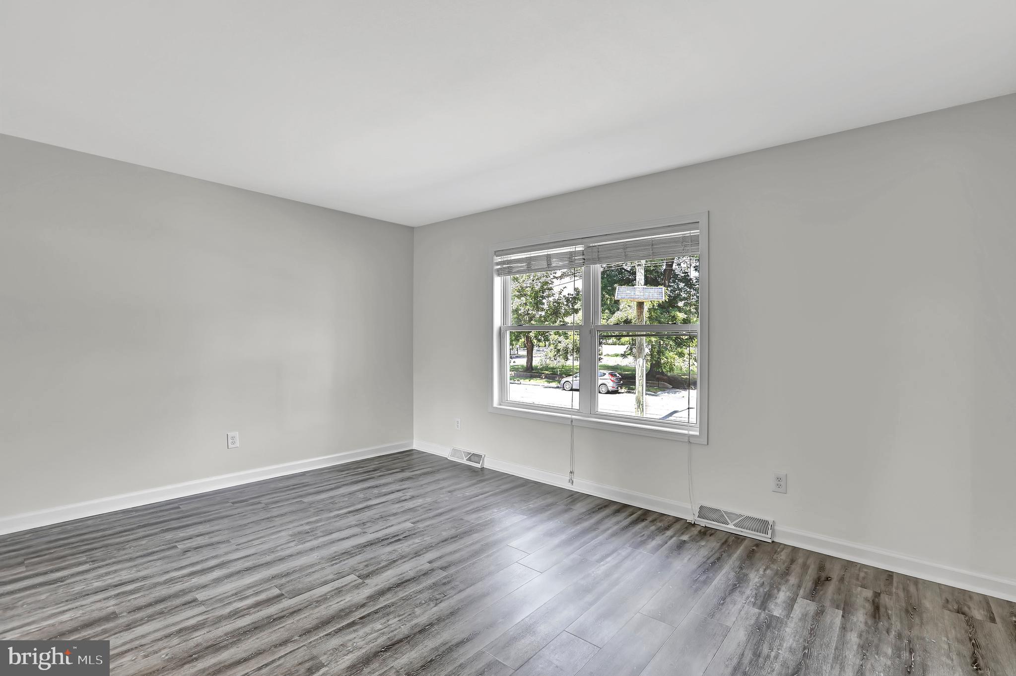 515 Ridge Avenue Hamilton, NJ 08610 - Photo 16 of 30 an empty room with wooden floor and windows