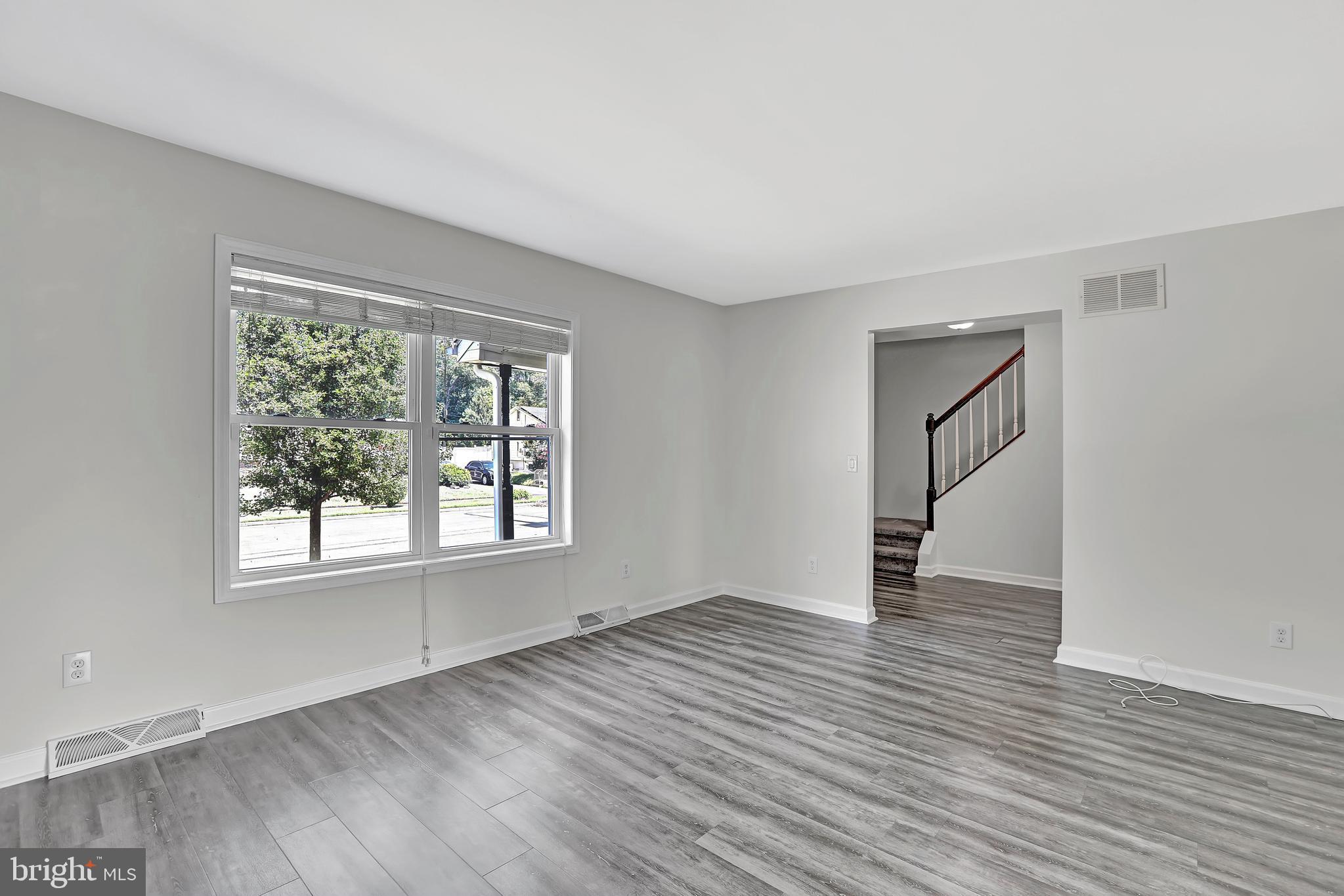 515 Ridge Avenue Hamilton, NJ 08610 - Photo 6 of 30 an empty room with wooden floor and windows