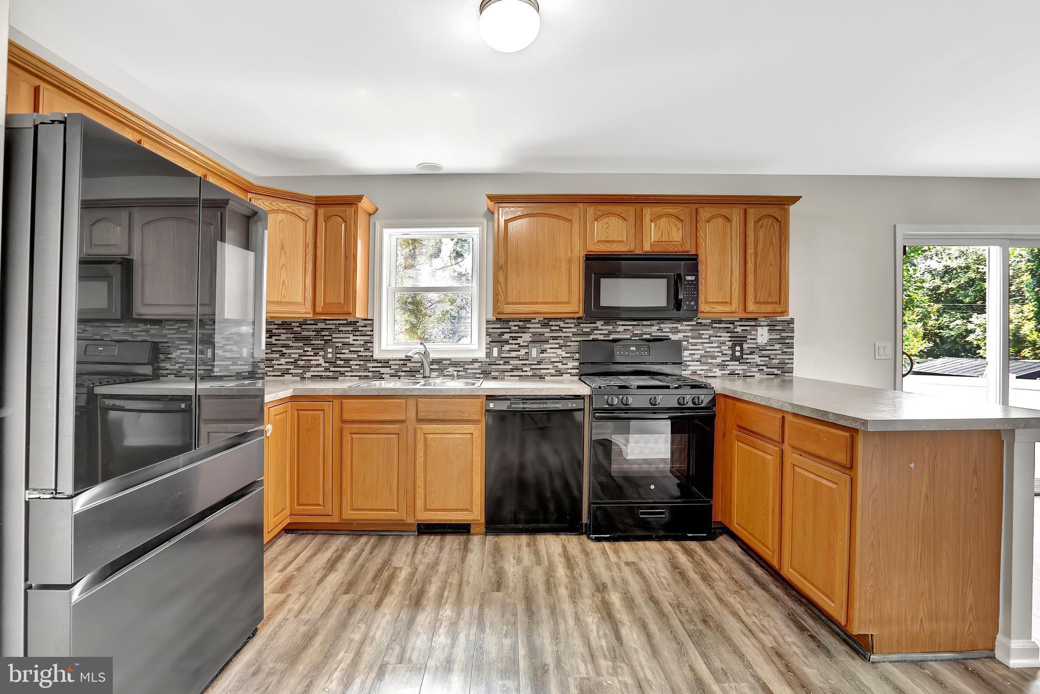 515 Ridge Avenue Hamilton, NJ 08610 - Photo 8 of 30 a kitchen with stainless steel appliances granite countertop a stove a sink and a refrigerator