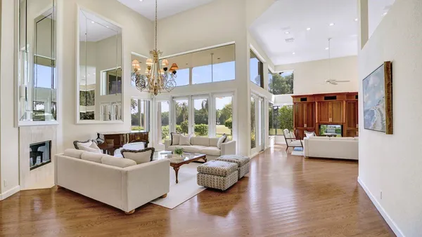 a living room with furniture and a chandelier