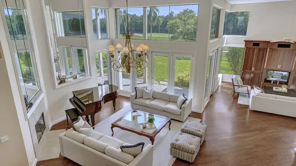 a living room with furniture and a chandelier