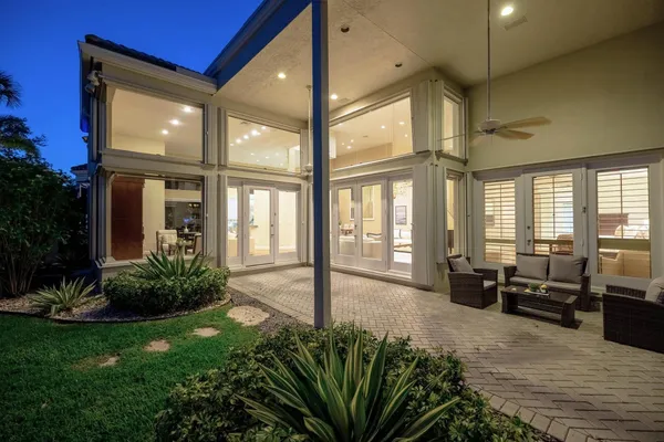 a living room with furniture kitchen and a large window