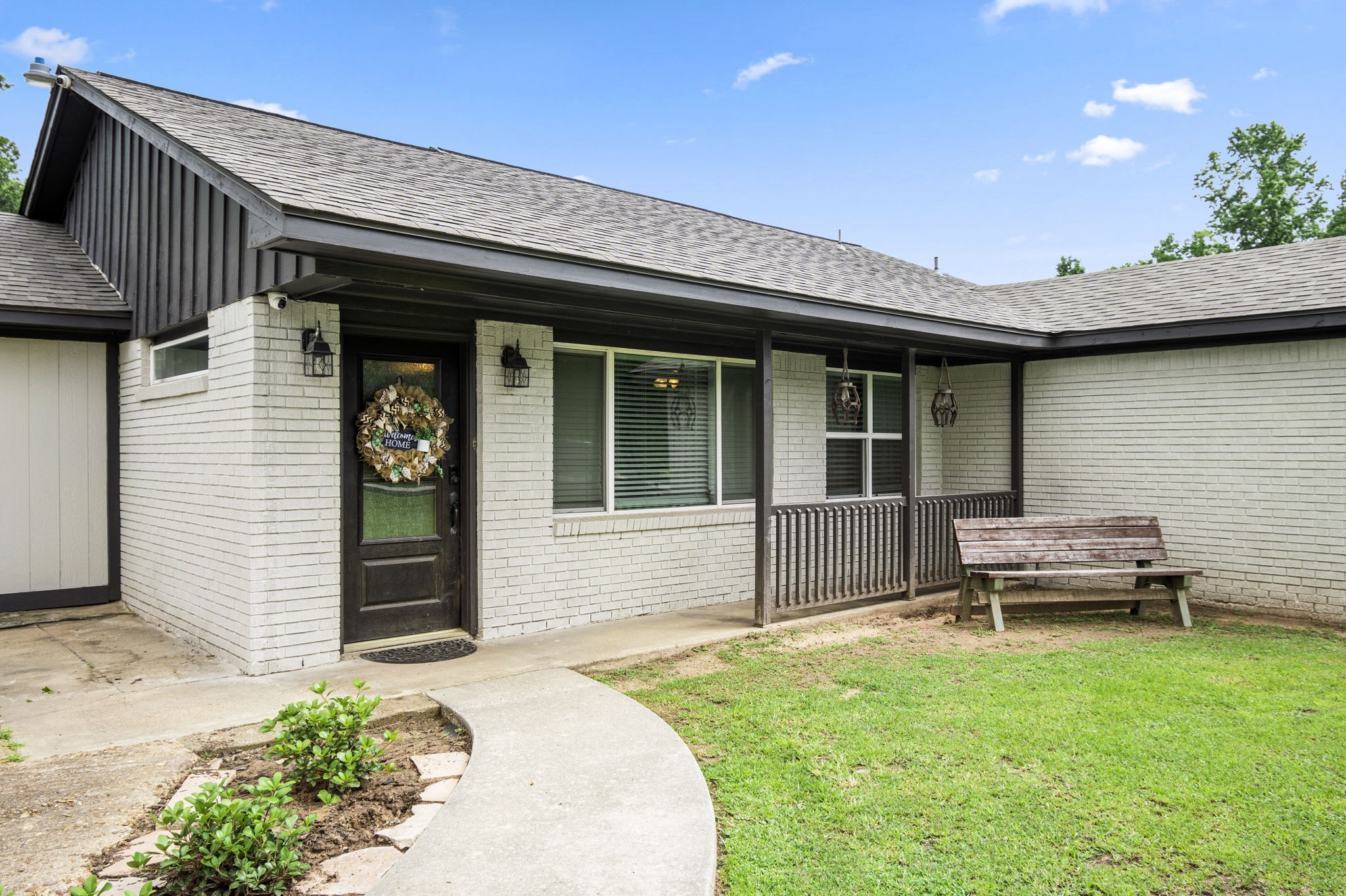 25311 Hardin Store Road Pinehurst, TX 77362 - Photo 4 of 39 a front view of a house with a garden and patio