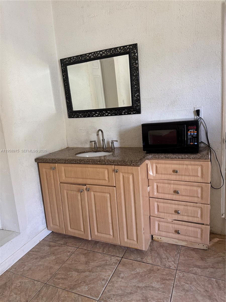 1822 Cleveland Street, Unit 3 Hollywood, FL 33020 - Photo 16 of 35 a bathroom with a sink and a mirror