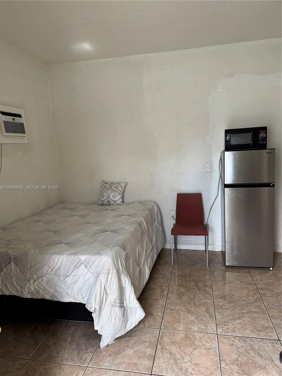 1822 Cleveland Street, Unit 3 Hollywood, FL 33020 - Photo 17 of 35 a bedroom with a bed and a chair