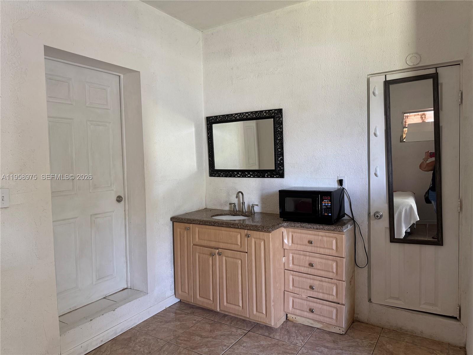 1822 Cleveland Street, Unit 3 Hollywood, FL 33020 - Photo 19 of 35 a kitchen with white cabinets and white appliances
