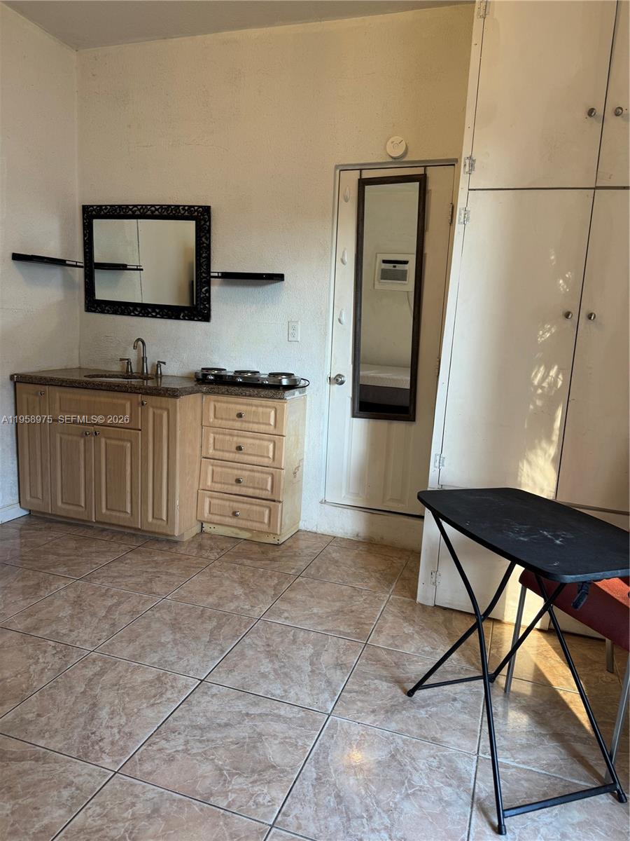 1822 Cleveland Street, Unit 3 Hollywood, FL 33020 - Photo 21 of 35 a kitchen with stainless steel appliances granite countertop a stove a sink and a microwave