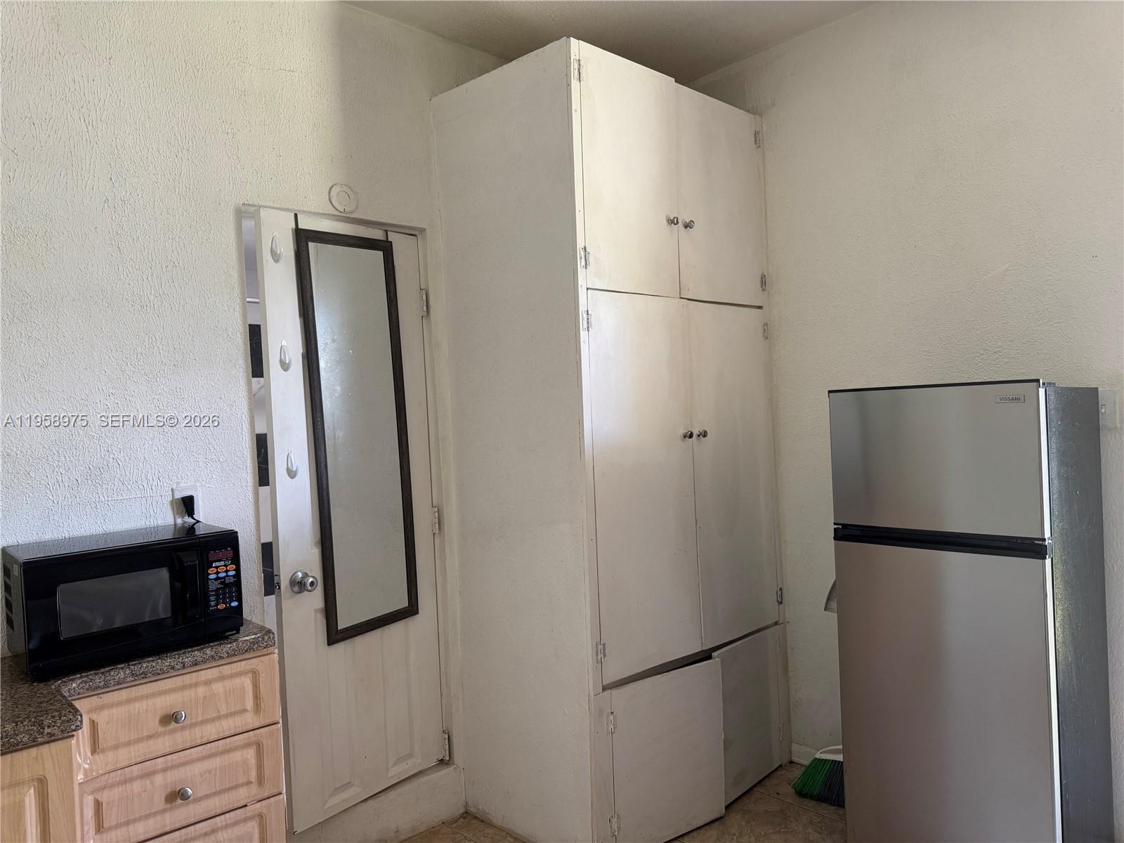 1822 Cleveland Street, Unit 3 Hollywood, FL 33020 - Photo 22 of 35 a white refrigerator freezer and a stove sitting inside of a kitchen