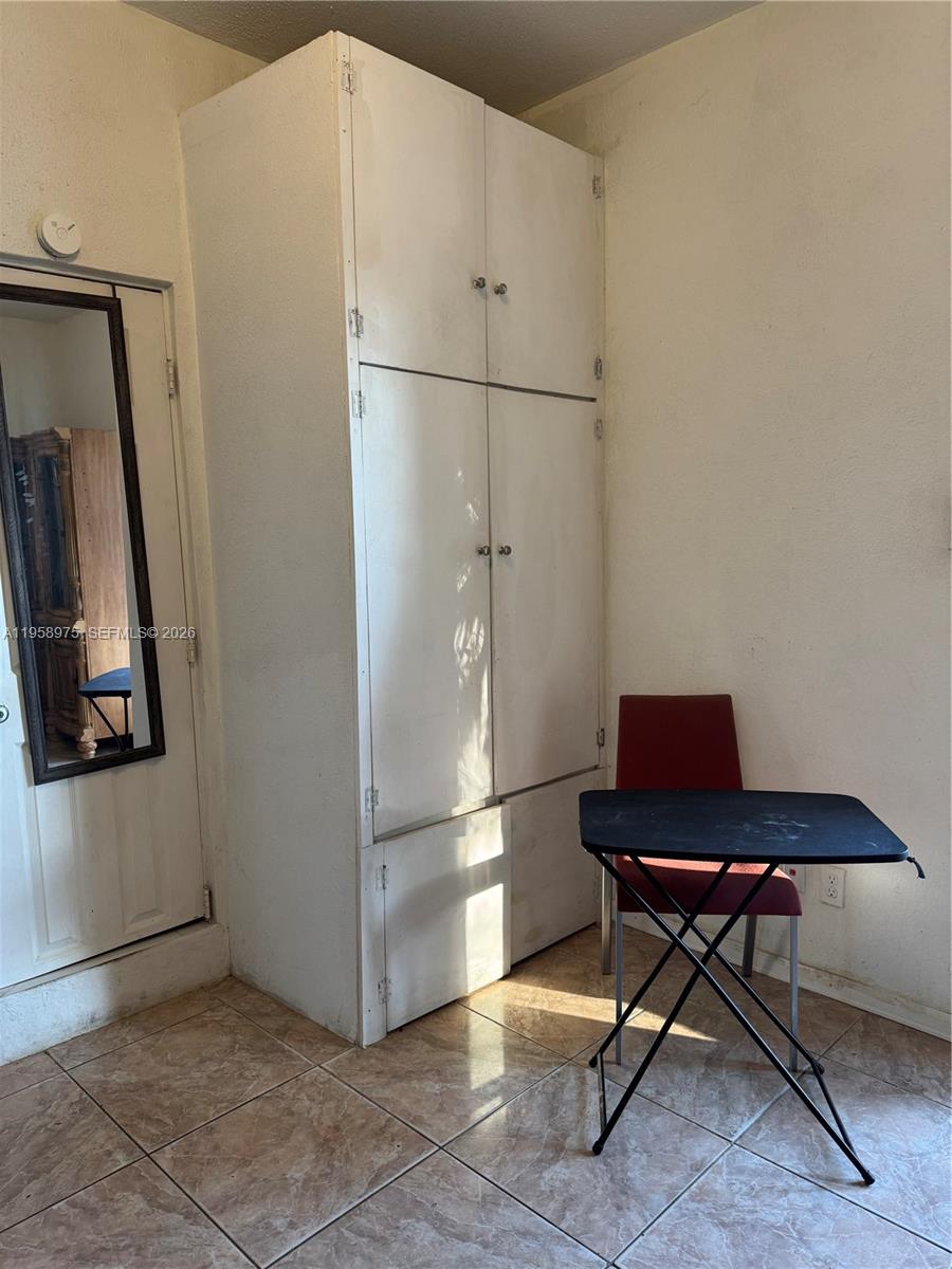 1822 Cleveland Street, Unit 3 Hollywood, FL 33020 - Photo 23 of 35 a room with a table and a refrigerator