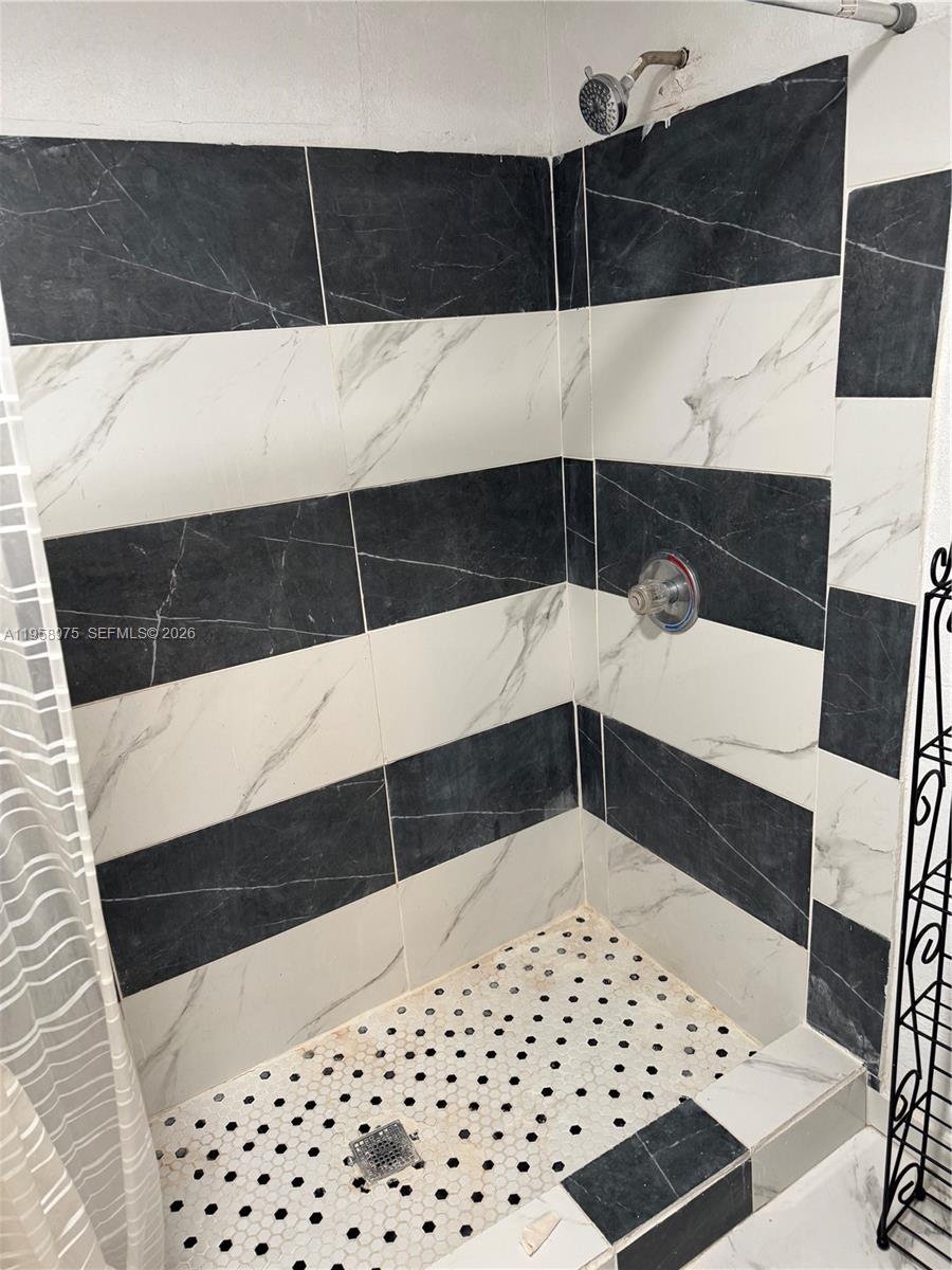 1822 Cleveland Street, Unit 3 Hollywood, FL 33020 - Photo 24 of 35 a bathroom with a bathtub and a shower