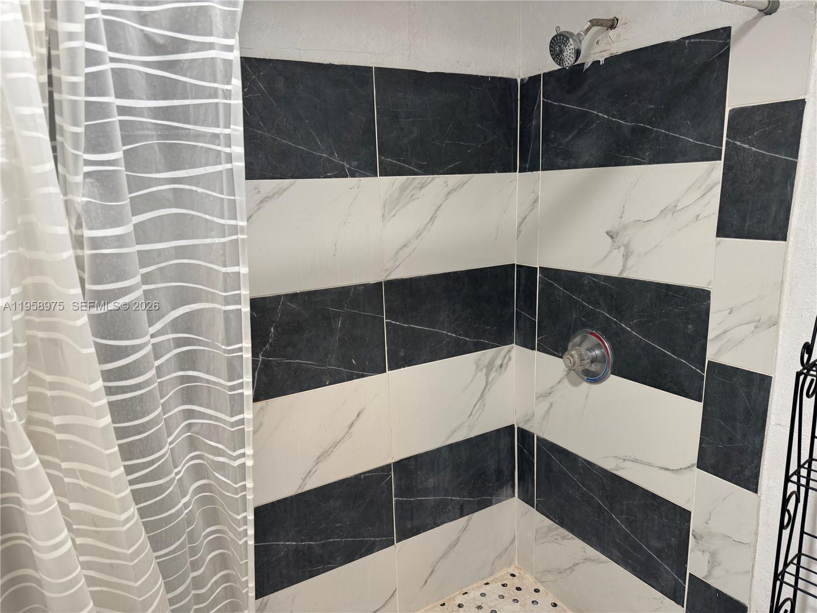 1822 Cleveland Street, Unit 3 Hollywood, FL 33020 - Photo 25 of 35 a bathroom with a sink and a mirror