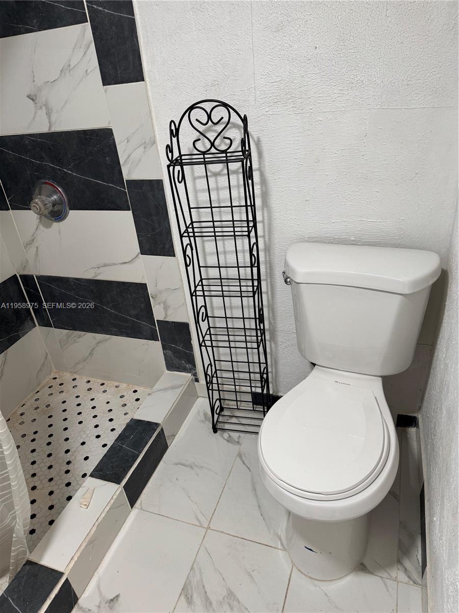 1822 Cleveland Street, Unit 3 Hollywood, FL 33020 - Photo 26 of 35 a bathroom with a toilet and a shower