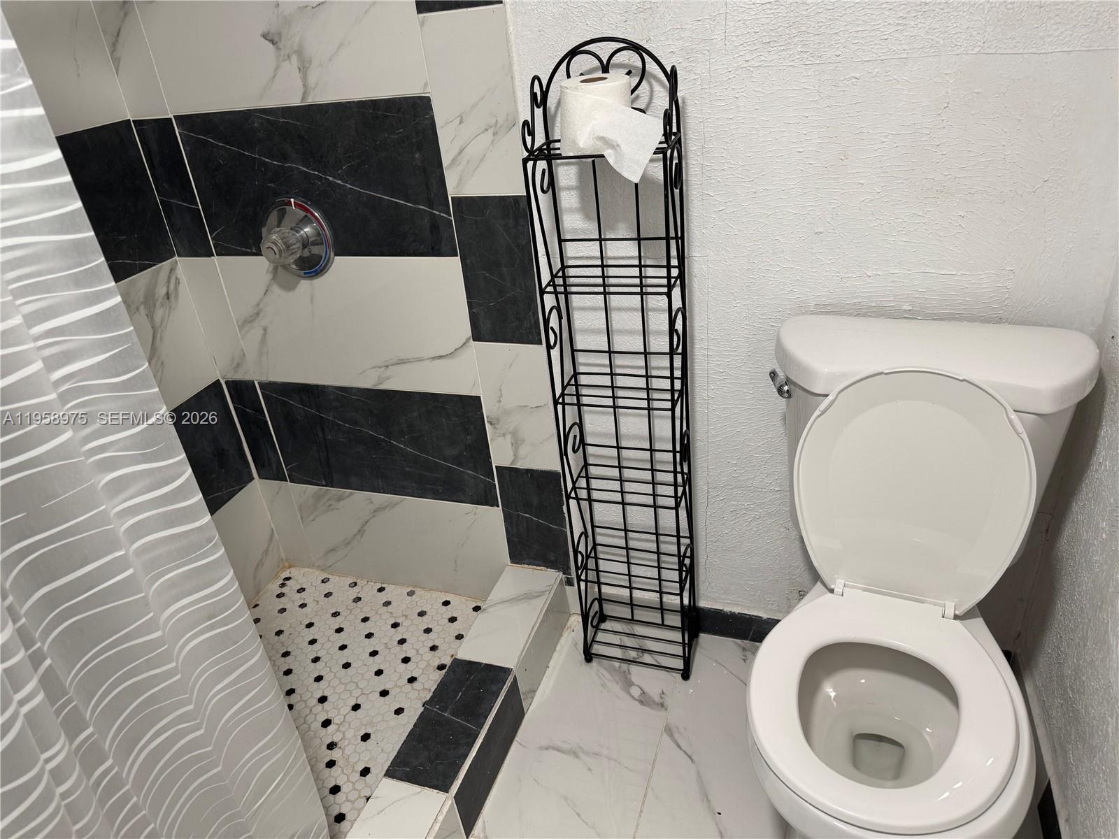 1822 Cleveland Street, Unit 3 Hollywood, FL 33020 - Photo 28 of 35 a bathroom with a toilet and a sink