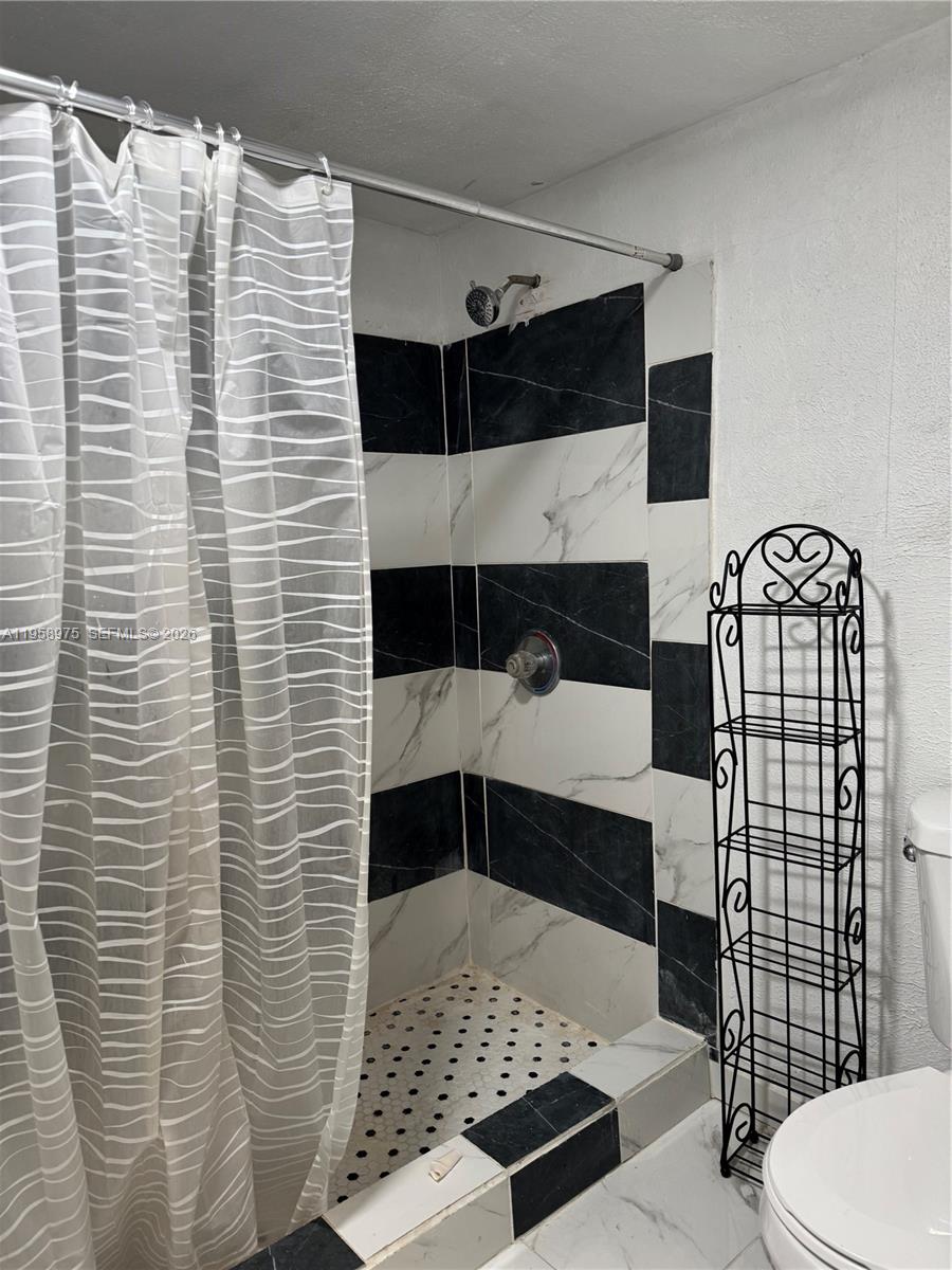 1822 Cleveland Street, Unit 3 Hollywood, FL 33020 - Photo 29 of 35 a bathroom with a sink and a toilet