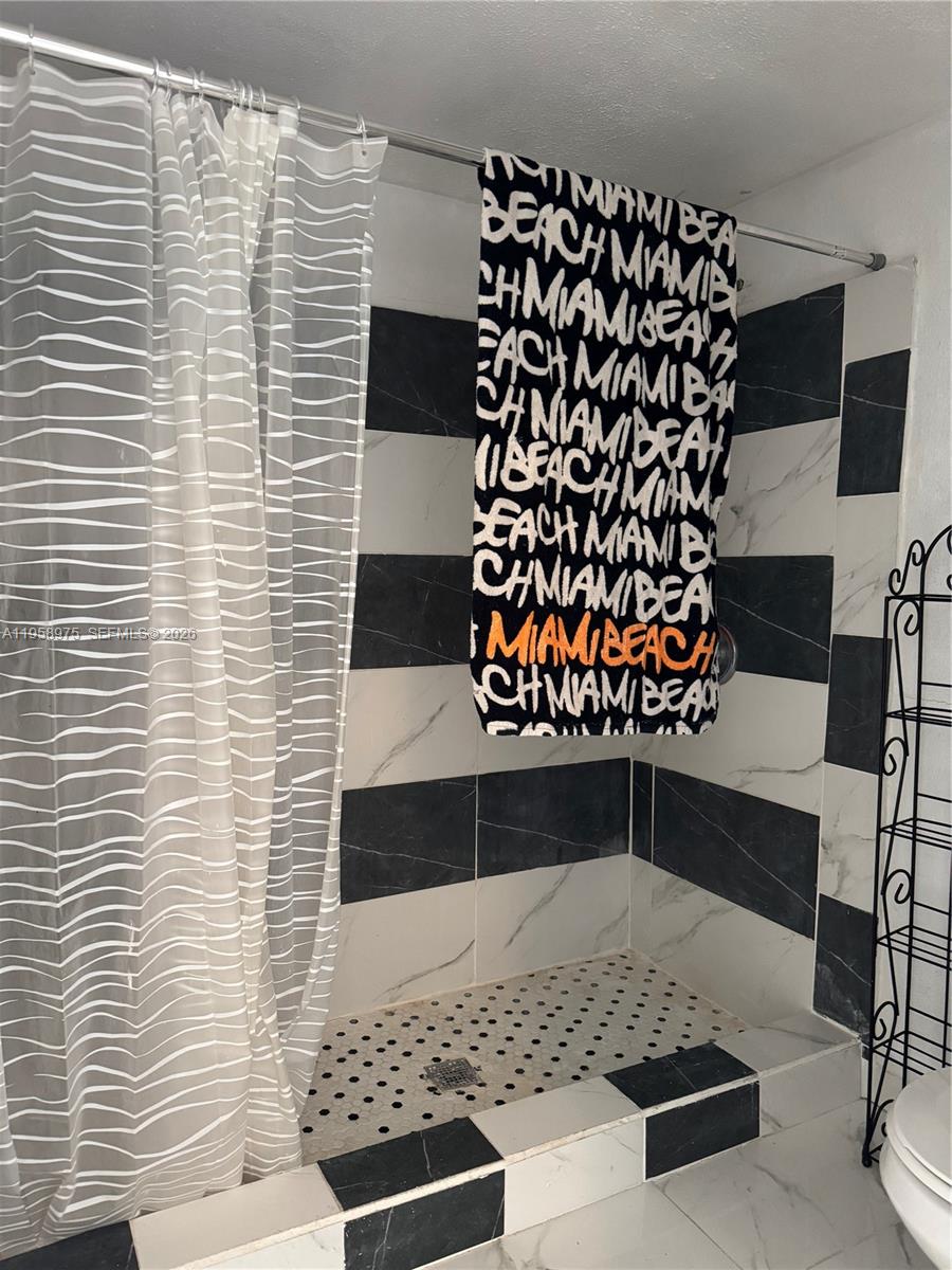 1822 Cleveland Street, Unit 3 Hollywood, FL 33020 - Photo 3 of 35 a view of a door and wooden bench