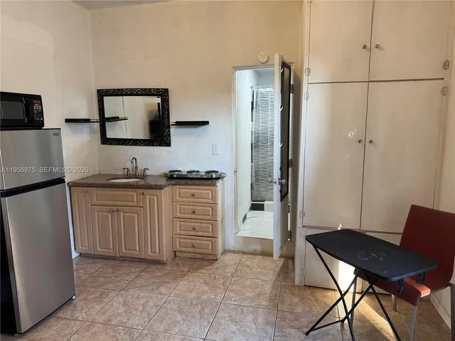a kitchen with stainless steel appliances a refrigerator and a stove top oven