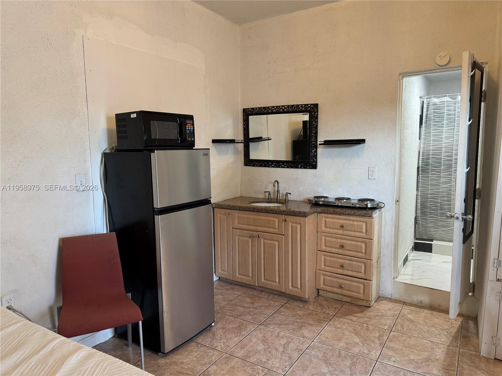 1822 Cleveland Street, Unit 3 Hollywood, FL 33020 - Photo 34 of 35 a kitchen with stainless steel appliances a refrigerator and a stove top oven