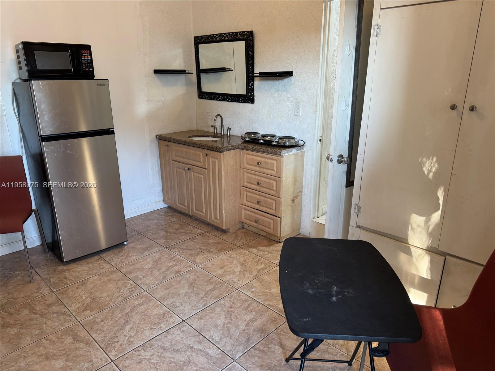 1822 Cleveland Street, Unit 3 Hollywood, FL 33020 - Photo 35 of 35 a kitchen with a refrigerator and cabinets